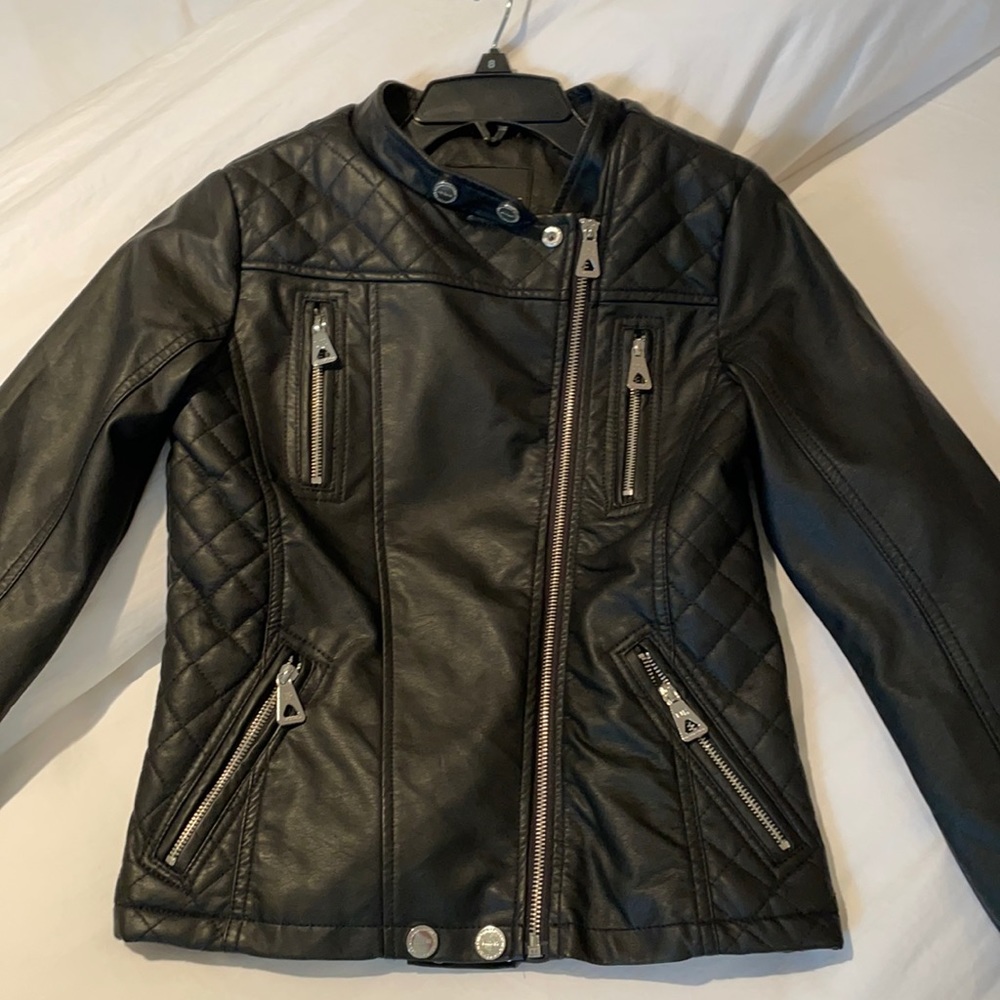 Material: Leather, Silver zippers, pockets, buttons and a zip up.